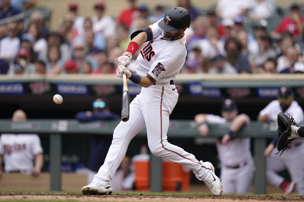 Minnesota Twins' Jake Cave hits a two-run double during the fifth inning of a baseball game against...