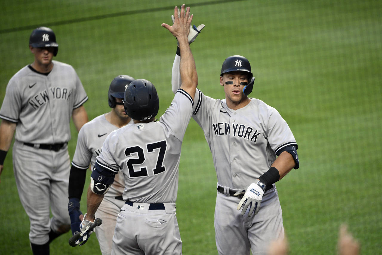 New York Yankees' Aaron Judge, right, celebrates his three-run home run with Giancarlo Stanton (27)...