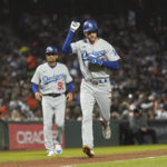 
              Los Angeles Dodgers' Trea Turner gestures in front of third base coach Dino Ebel (91) after hitting a home run against the San Francisco Giants during the seventh inning of a baseball game in San Francisco, Monday, Aug. 1, 2022. (AP Photo/Jeff Chiu)
            