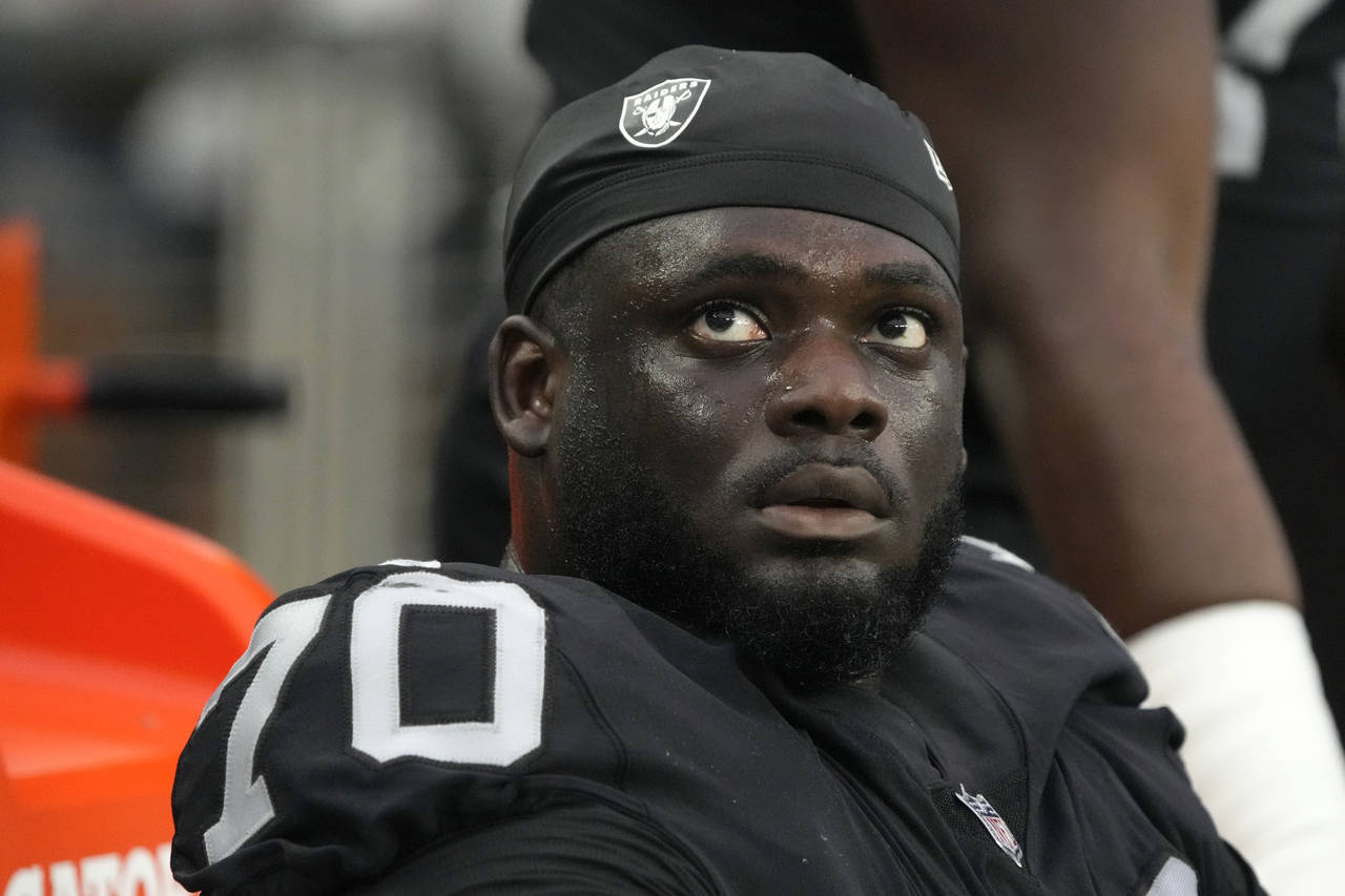 FILE - Las Vegas Raiders offensive tackle Alex Leatherwood looks up during the first half of the te...