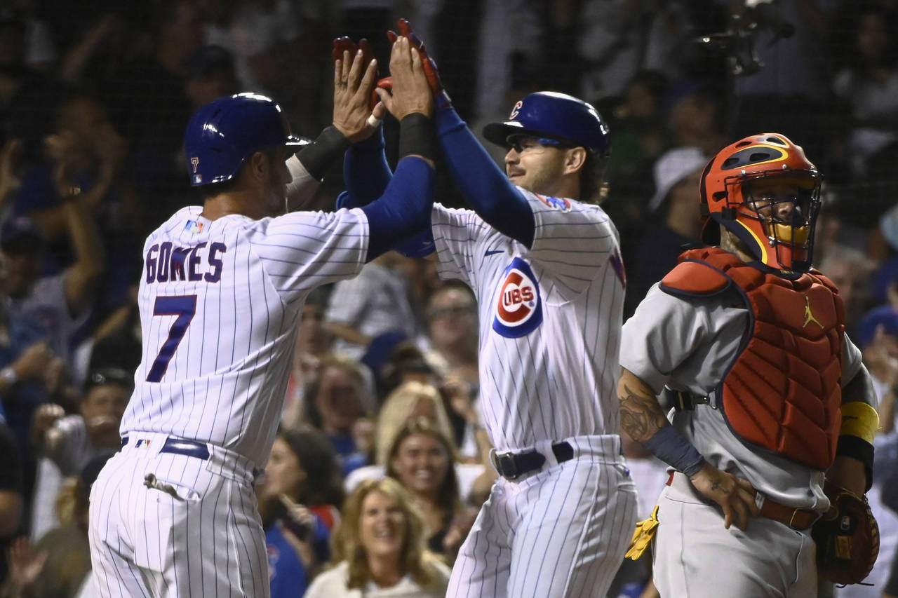 Chicago Cubs' Zach McKinstry, right, celebrates with Yan Gomes (7) after they scored on McKinstry's...