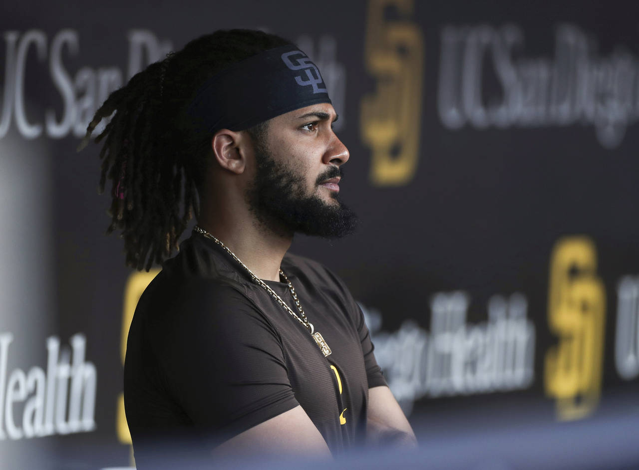 FILE - San Diego Padres' Fernando Tatis Jr. looks out from the dugout prior to the team's baseball ...