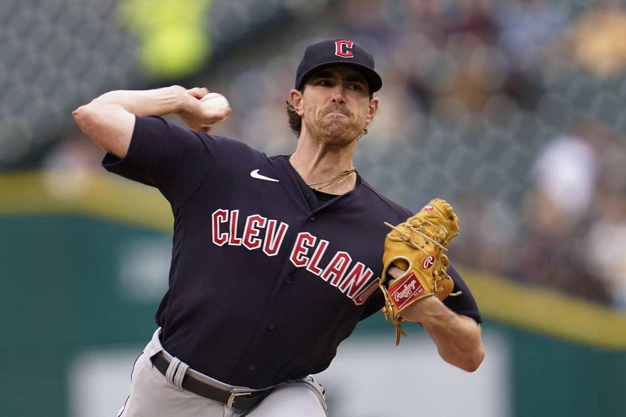 Cleveland Guardians pitcher Shane Bieber throws against the Detroit Tigers in the first inning of a...