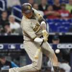 
              San Diego Padres' Manny Machado hits a double to center field during the seventh inning of a baseball game against the Miami Marlins, Tuesday, Aug. 16, 2022, in Miami. The Padres scored three runs tying the game. (AP Photo/Marta Lavandier)
            