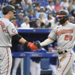 
              Baltimore Orioles' Ryan McKenna, right, celebrates with Ryan Mountcastle after scoring against the Toronto Blue Jays during the first inning of a baseball game Monday, Aug. 15, 2022, in Toronto. (Jon Blacker/The Canadian Press via AP)
            