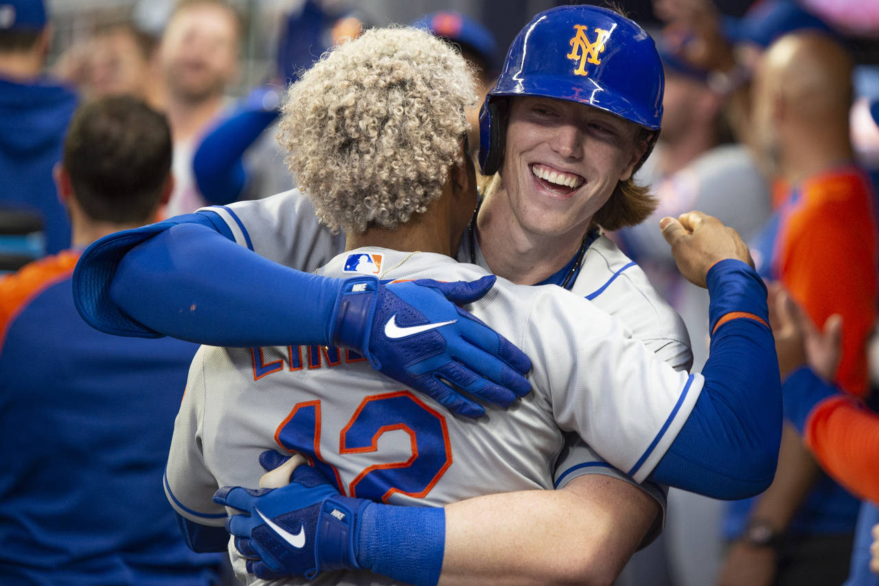 New York Mets' Francisco Lindor, back to camera, celebrates with Brett Baty, who hit a two-run home...