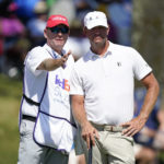 
              Lucas Glover, right, talks with his caddie before putting on the 18th green during the final round of the St. Jude Championship golf tournament, Sunday, Aug. 14, 2022, in Memphis, Tenn. (AP Photo/Mark Humphrey)
            