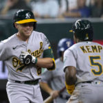 
              Oakland Athletics' Nick Allen (2) and Tony Kemp (5) celebrate Allen's solo home run during the third inning of the team's baseball game against the Texas Rangers in Arlington, Texas, Monday, Aug. 15, 2022. (AP Photo/Tony Gutierrez)
            