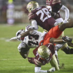 
              Duquesne running back JaMario Clements (23) is upended by Florida State defensive back Jarques McClellion (1) in the fourth quarter of an NCAA college football game Saturday, Aug. 27, 2022, in Tallahassee, Fla. (AP Photo/Phil Sears)
            