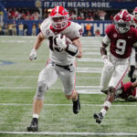 
              FILE - Georgia tight end Brock Bowers (19) runs into the end zone for a touchdown against Alabama defensive back Jordan Battle (9) during the second half of the Southeastern Conference championship NCAA college football game, Saturday, Dec. 4, 2021, in Atlanta. Bowers was named to The Associated Press preseason All-America team, Monday, Aug. 22, 2022. (AP Photo/John Bazemore, File)
            