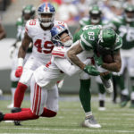 
              New York Giants safety Nathan Meadors (34) tackles New York Jets tight end Tyler Conklin (83) in the first half of a preseason NFL football game, Sunday, Aug. 28, 2022, in East Rutherford, N.J. (AP Photo/Adam Hunger)
            