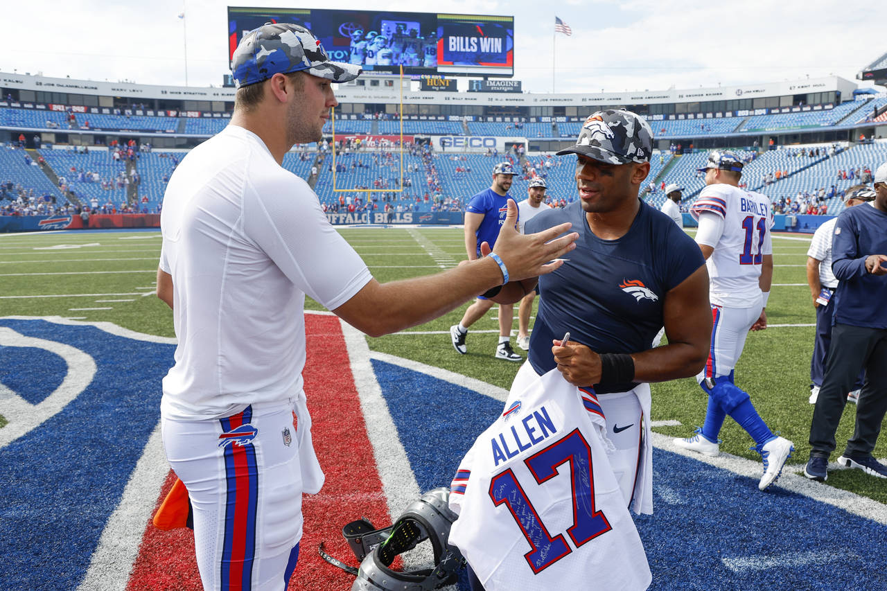 Buffalo Bills quarterback Josh Allen, left, and Denver Broncos quarterback Russell Wilson greet one...