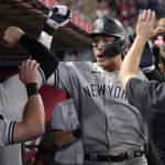
              New York Yankees' Aaron Judge is congratulated by teammates in the dugout after hitting a solo home run during the eighth inning of a baseball game against the Los Angeles Angels Monday, Aug. 29, 2022, in Anaheim, Calif. This was Judge's 50th home run of the season. (AP Photo/Mark J. Terrill)
            