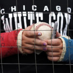 
              A fan holds a ball while waiting for autographs from players before a baseball game between the Arizona Diamondbacks and the Chicago White Sox in Chicago, Sunday, Aug. 28, 2022. (AP Photo/Nam Y. Huh)
            