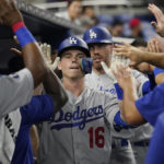 
              Los Angeles Dodgers' Will Smith (16) is congratulated by his teammates after hitting a home run in the third inning of a baseball game against the Miami Marlins, Monday, Aug. 29, 2022, in Miami. (AP Photo/Marta Lavandier)
            