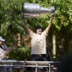 
              Colorado Avalanche's Nazem Kadri holds the Stanley Cup from atop a fire truck during a parade in London, Ontario on Saturday, Aug. 27, 2022. Kadri, 31, won the cup for the first time while playing with the Colorado Avalanche. (Geoff Robins/The Canadian Press via AP)
            