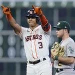 
              Houston Astros' Jeremy Pena, left, celebrates next to Oakland Athletics second baseman Nick Allen after hitting an RBI--double during the sixth inning of a baseball game Saturday, Aug. 13, 2022, in Houston. (AP Photo/Kevin M. Cox)
            