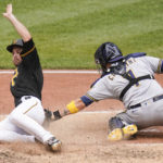 
              Pittsburgh Pirates' Greg Allen, left, scores past the tag of Milwaukee Brewers catcher Victor Caratini (7) on a hit by Ben Gamel in the seventh inning the a baseball game, Thursday, Aug. 4, 2022, Pittsburgh. (AP Photo/Keith Srakocic)
            