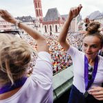 
              Laura Freigang, left, and Lina Magull, of the German women's team, celebrate on the balcony of the Roemer town hall, upon the team's return from the Women's Euro 2022 soccer, after losing to England in Sunday's final, in Frankfurt, Monday, Aug. 1, 2022. (Uwe Anspach /dpa via AP)
            