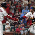 
              St. Louis Cardinals' Brendan Donovan, right, is congratulated by teammate Corey Dickerson (25) after scoring during the sixth inning of a baseball game Sunday, Aug. 28, 2022, in St. Louis. (AP Photo/Jeff Roberson)
            