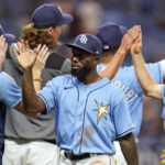 
              Tampa Bay Rays' Randy Arozarena, center, high fives teammates after the team defeated the Los Angeles Angels during a baseball game Monday, Aug. 22, 2022, in St. Petersburg, Fla. (AP Photo/Chris O'Meara)
            