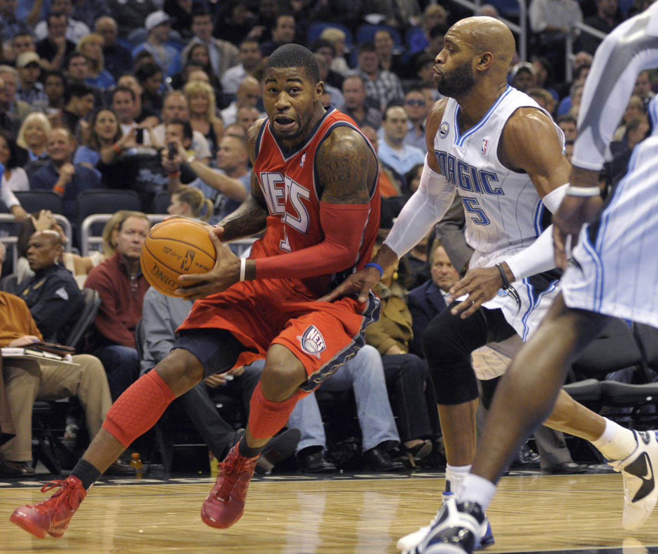 FILE - New Jersey Nets guard Terrence Williams, left, drives past Orlando Magic guard Vince Carter ...