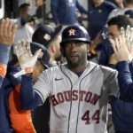 
              Houston Astros' Yordan Alvarez celebrates in the dugout after scoring on a sacrifice fly by Trey Mancini during the fourth inning of a baseball game against the Chicago White Sox Wednesday, Aug. 17, 2022, in Chicago. (AP Photo/Charles Rex Arbogast)
            