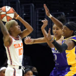 
              Connecticut Sun guard Courtney Williams, left, tries to pass while under pressure from Los Angeles Sparks forward Olivia Nelson-Ododa, center, and guard Brittney Sykes during the first half of a WNBA basketball game Thursday, Aug. 11, 2022, in Los Angeles. (AP Photo/Mark J. Terrill)
            