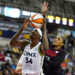 
              Minnesota Lynx center Sylvia Fowles (34) is fouled as she shoots by Indiana Fever guard Victoria Vivians (35) in the second half of a WNBA basketball game in Indianapolis, Friday, July 15, 2022. The Lynx defeated the Fever 87-77. (AP Photo/Michael Conroy)
            