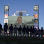 
              A tribute to broadcaster Vin Scully is shown on a video board at Oracle Park above Los Angeles Dodgers players and coaches before a baseball game between the San Francisco Giants and the Dodgers in San Francisco, Wednesday, Aug. 3, 2022. (AP Photo/Jeff Chiu)
            