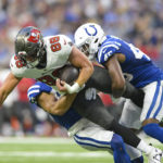 
              Tampa Bay Buccaneers tight end Cade Otton (88) is tackled by Indianapolis Colts linebacker E.J. Speed, right, and defensive tackle Byron Cowart in the first half of an NFL preseason preseason football game in Indianapolis, Saturday, Aug. 27, 2022. (AP Photo/Doug McSchooler)
            