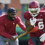 
              L'Damian Washington, left, runs a drill with Oklahoma wide receiver Brian Darby, right, during an NCAA college football practice, Monday, Aug. 8, 2022, in Norman, Okla. Oklahoma assistant head football coach Cale Gundy says he has resigned after using offensive language during a film session. Washington, who had been an offensive analyst, will coach receivers on an interim basis. (AP Photo/Sue Ogrocki)
            