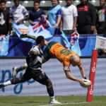 
              Australia's James Turner, right, leaps and goes over to score a try despite Fiji's Jerry Tuwai attempting to block during their Los Angeles rugby sevens series semifinal match at Dignity Health Sports Park in Carson, Calif., Sunday, 28, Aug. 27, 2022. (AP Photo/Marcio Jose Sanchez)
            