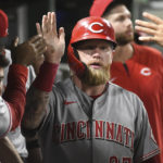 
              Cincinnati Reds' Jake Fraley is congratulated after he scored against the Pittsburgh Pirates during the eighth inning of a baseball game Friday, Aug. 19, 2022, in Pittsburgh. (AP Photo/Philip G. Pavely)
            