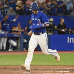 
              Toronto Blue Jays' Danny Jansen scores on a single by Vladimir Guerrero Jr. against the Chicago Cubs during the fifth inning of a baseball game Tuesday, Aug. 30, 2022, in Toronto. (Jon Blacker/The Canadian Press via AP)
            
