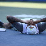 
              Nick Kyrgios, of Australia, lies on the court after he defeated Yoshihito Nishioka, of Japan, during a final at the Citi Open tennis tournament Sunday, Aug. 7, 2022, in Washington. Kyrgios won 6-4, 6-3.(AP Photo/Nick Wass)
            