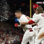 
              St. Louis Cardinals' Tyler O'Neill, left, is congratulated by teammates Brendan Donovan (33) and Andrew Knizner after being hit by a pitch with the bases loaded to end a baseball game against the Colorado Rockies Tuesday, Aug. 16, 2022, in St. Louis. The Cardinals won the game 5-4. (AP Photo/Jeff Roberson)
            