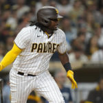 
              San Diego Padres' Josh Bell watches his RBI single during the sixth inning of the team's baseball game against the San Francisco Giants, Tuesday, Aug. 9, 2022, in San Diego. (AP Photo/Gregory Bull)
            