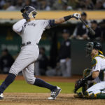 
              New York Yankees' Aaron Judge, left, hits a three-run home run in front of Oakland Athletics catcher Sean Murphy during the fifth inning of a baseball game in Oakland, Calif., Friday, Aug. 26, 2022. (AP Photo/Jeff Chiu)
            