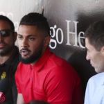 
              San Diego Padres' Fernando Tatis Jr., center, speaks to the media about his 80 game suspension from baseball after testing positive for Clostebol, a performance-enhancing substance in violation of Major League Baseball's Joint Drug Prevention and Treatment Program, Tuesday, Aug. 23, 2022, in San Diego. (AP Photo/Derrick Tuskan)
            