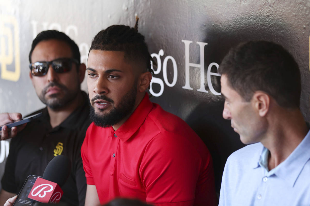 San Diego Padres' Fernando Tatis Jr., center, speaks to the media about his 80 game suspension from...