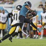 
              Jacksonville Jaguars wide receiver Marvin Jones Jr., right, makes a reception in front of Pittsburgh Steelers linebacker Robert Spillane (41) during the first half of an NFL preseason football game, Saturday, Aug. 20, 2022, in Jacksonville, Fla. (AP Photo/Gary McCullough)
            
