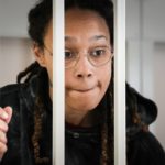 
              FILE - WNBA star and two-time Olympic gold medalist Brittney Griner speaks to her lawyers standing in a cage at a court room prior to a hearing, in Khimki just outside Moscow, Russia, Tuesday, July 26, 2022. Closing arguments in Brittney Griner's cannabis possession case in Russia are set for Thursday. That's nearly six months after the American basketball star was arrested at a Moscow airport in a case that has reached the highest levels of U.S.-Russia diplomacy. (AP Photo/Alexander Zemlianichenko, Pool, File)
            
