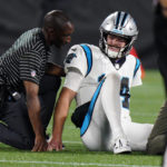 
              Carolina Panthers quarterback Sam Darnold is treated after getting injured during the second half of an NFL preseason football game against the Buffalo Bills on Friday, Aug. 26, 2022, in Charlotte, N.C. (AP Photo/Jacob Kupferman)
            