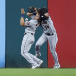 
              Houston Astros left fielder Aledmys Diaz, left, and center fielder Jake Meyers collide while going for a ball hit by Cleveland Guardians' Austin Hedges during the eighth inning of a baseball game Thursday, Aug. 4, 2022, in Cleveland. Hedges reached on an error by Diaz. (AP Photo/Ron Schwane)
            