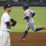 
              New York Mets' Franciso Lindor runs the bases on his solo home run, past Atlanta Braves starting pitcher Jake Odorizzi during the first inning of a  baseball game Wednesday, Aug. 17, 2022, in Atlanta. (Curtis Compton/Atlanta Journal-Constitution via AP)
            