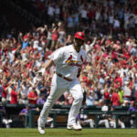 
              St. Louis Cardinals' Albert Pujols celebrates as he rounds the bases after hitting a grand slam during the third inning of a baseball game against the Colorado Rockies Thursday, Aug. 18, 2022, in St. Louis. (AP Photo/Jeff Roberson)
            