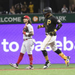 
              Pittsburgh Pirates' Rodolfo Castro, right, passes Cincinnati Reds second baseman Jonathan India after hitting a solo home run off pitcher Justin Dunn during the fourth inning of a baseball game, Saturday, Aug. 20, 2022, in Pittsburgh. (AP Photo/Philip G. Pavely)
            