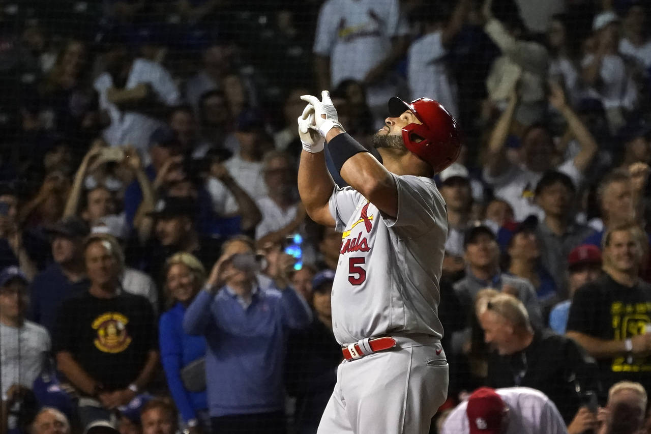 St. Louis Cardinals' Albert Pujols celebrates his 693rd career home run off Chicago Cubs starting p...
