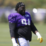 
              Minnesota Vikings defensive tackle Dalvin Tomlinson (94) laughs with teammates at the NFL football team's practice facility in Eagan, Minn., Friday, Aug. 5, 2022. (AP Photo/Stacy Bengs)
            